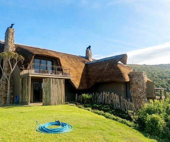 A premium thatched coastal estate treated with certified high-penetration fire-retardant spray for national building code compliance.