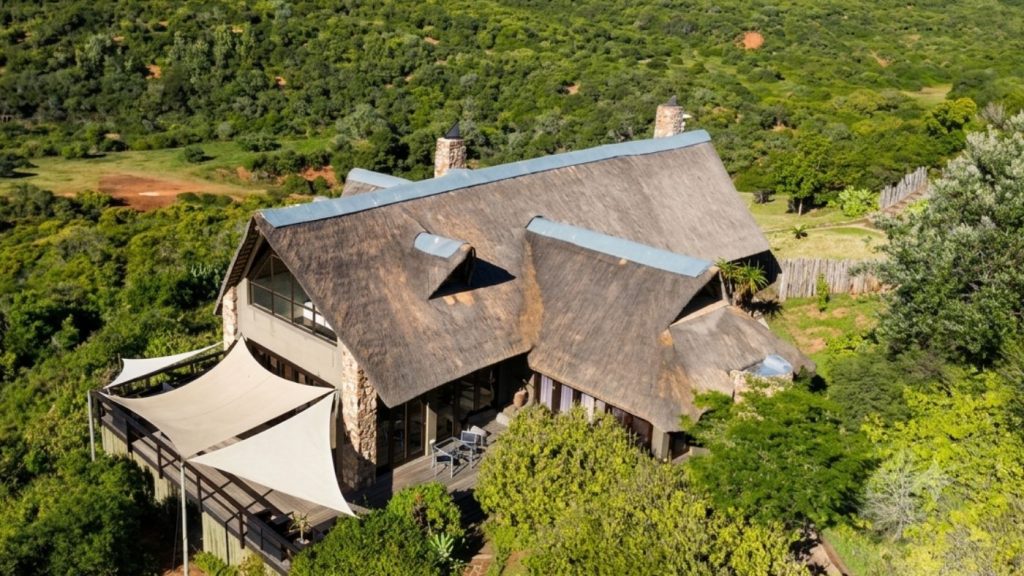 Fire Safety for Thatched Roofs Aerial view of a large thatched lodge surrounded by bushveld in the Eastern Cape
