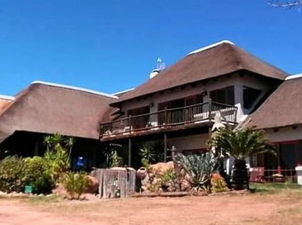 Projects An expansive double-story residential coastal estate featuring a massive, premium high-density thatched roof structure with custom timber balconies and landscaped gardens