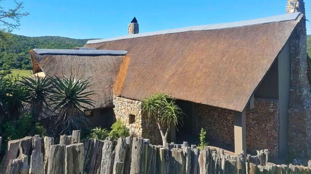How Often Should You Service Your Thatched Roof? Well-maintained thatched roof lodge with stone walls and neatly combed thatch in Eastern Cape